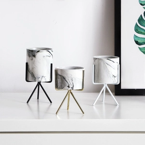 Three Nordic marble pattern ceramic plant pots with gold, black and white metal stands