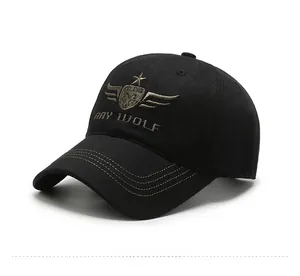 Detail of black baseball cap with golden wolf embroidery and yellow brim stitching