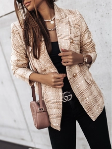 Detailed view of tweed plaid jacket with vintage gold buttons and woven texture
