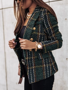 Detailed side view of dark green plaid tweed blazer featuring golden lion buttons