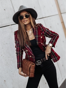 Detailed view of red plaid tweed blazer featuring golden lion head buttons and texture