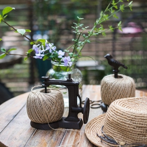 Vintage cast iron sewing machine twine holder with rustic rope for garden decoration