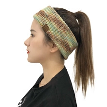 Side view of a thick multicolored knit ear warmer headband with a small leather label