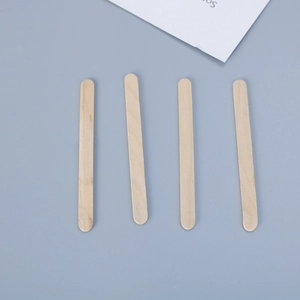 Flat lay of four smooth natural wooden popsicle sticks for DIY resin coaster crafts