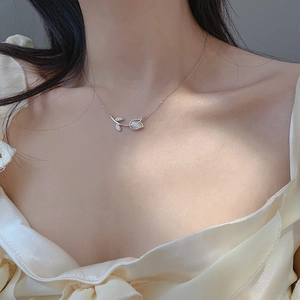 Elegant silver tulip flower pendant necklace with cat eye opal inlay on female model