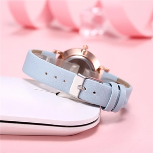 Orologio donna minimalista con cinturino in pelle celeste e cassa oro rosa su sfondo rosa