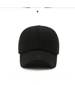 Close-up of black wool-like baseball cap featuring a detailed metallic JEANS logo badge