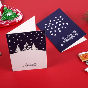 Detail of blue and white Merry Christmas cards on festive red background with ornaments