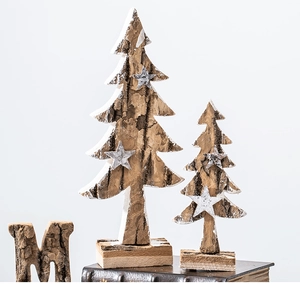 Detail of natural birch bark Christmas trees with snowy stars on vintage book stand