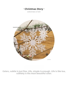 Sparkling transparent snowflake ornaments hanging on a rustic branch for Christmas decor
