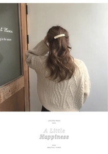 Detailed back view of an 8.5cm beige marble acetate hair clip on a model's hair