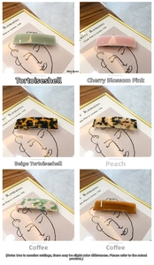 Detail view of 8.5cm acetate rectangle spring hair clips in 6 different colors and patterns