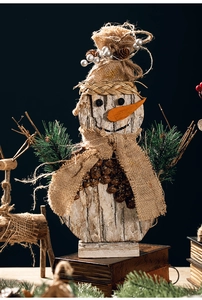Detail of handmade rustic wooden snowman with natural bark texture and burlap hat