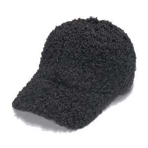 Detailed macro view of the black lamb wool texture and fabric on this warm baseball cap