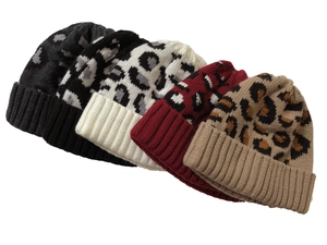 Flat lay of leopard print knitted beanies in black, white, red, and brown color options