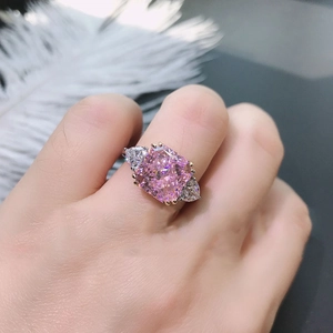 Pink cushion-cut synthetic tourmaline ring in golden setting worn by a female model