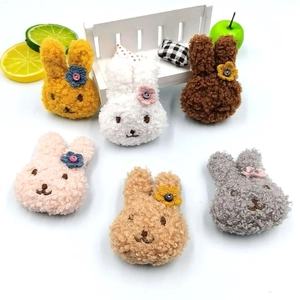 Detailaufnahme bunter Teddy-Plüsch Hasen-Accessoires mit kleinen Blumenknöpfen