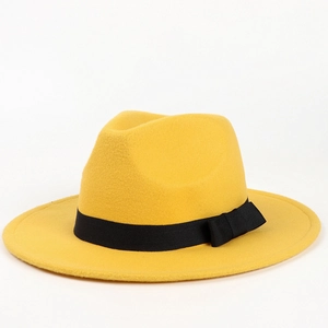 Detail of yellow wool fedora hat with a black grosgrain ribbon and classic bow
