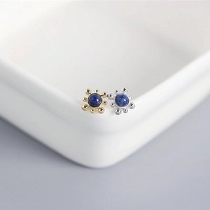 Macro shot of S925 silver stud earrings with blue lapis lazuli in sunburst design