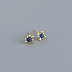 Macro shot of S925 sterling silver starburst earrings with round blue lapis lazuli