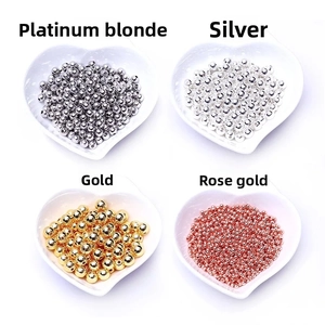 Macro view of gold-plated round spacer beads in white, silver, gold, and rose gold colors