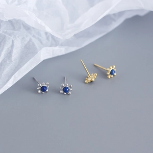 Detailed shot of S925 silver and gold studs with natural round lapis lazuli stones