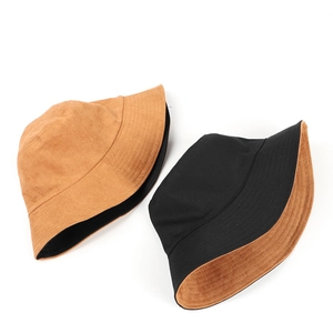 Macro detail of reversible suede bucket hat showing neat stitching and soft texture