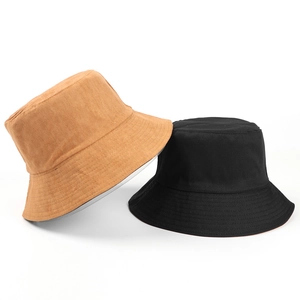 Dual-sided faux suede bucket hat in black and khaki with a flat top and wide brim design