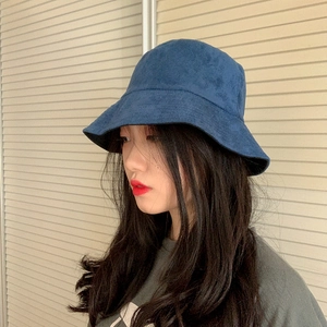 Navy blue faux suede bucket hat for women with a structured wide brim and minimalist design