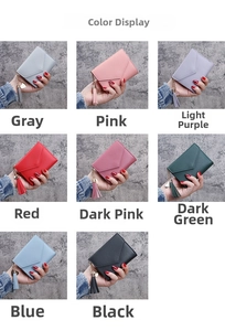 Close-up of compact leather wallets with metallic tassel and heart pendant in various colors