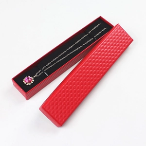 Top view of a long red jewelry gift box with textured diamond pattern and black lining