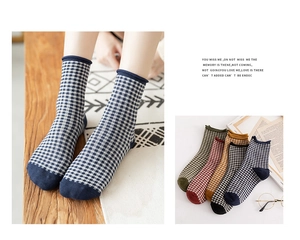 Detail of vintage plaid cotton socks featuring rolled cuffs and reinforced toes in multi colors