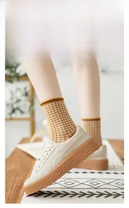 Retro style beige platform sneakers paired with yellow plaid cotton crew socks