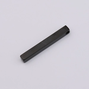 Detailed macro view of black mirror-polished rectangular bar pendant with top hanging hole