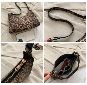 Detail view of leopard print baguette bag showing hardware, zipper and interior storage