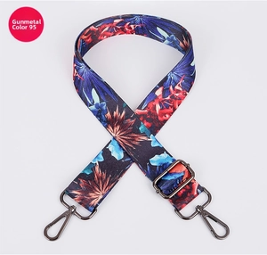 Detail of adjustable floral strap with ethnic pattern and gunmetal rotating metal buckles