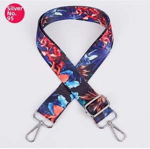 Detail of adjustable tropical floral strap in navy blue with silver metal swivel hooks