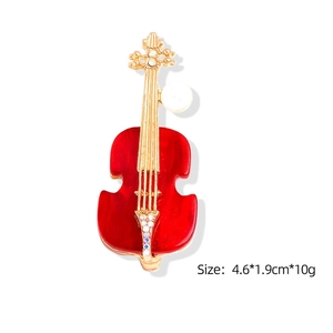 Elegant gold-tone violin brooch with red enamel finish and sparkling crystal accents