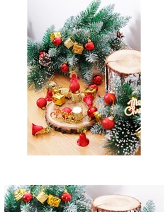 Detail of red and gold Christmas tree ornaments including bells and Merry Christmas sign