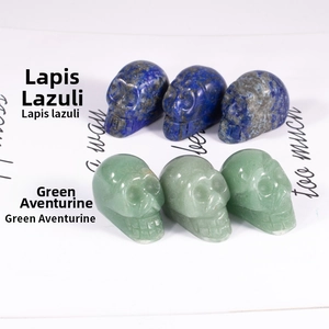 Detailed view of hand-carved skulls in natural lapis lazuli and green aventurine stone