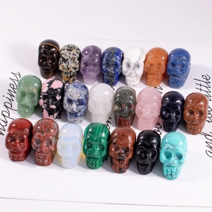 Detailed overhead view of assorted natural carved crystal skulls in various colors
