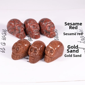 Detailed macro view of sesame red marble and gold sand stone skull carvings
