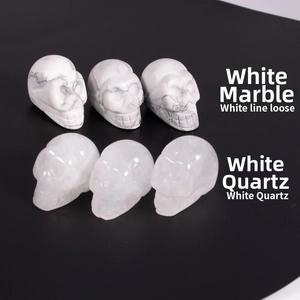 Detailed comparison of polished white howlite and translucent white quartz skull carvings