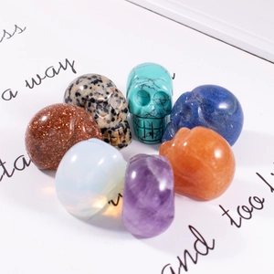 Set of seven natural crystal skull carvings in diverse gemstones for Halloween decor