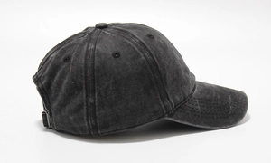 Detail view of washed dark grey cotton baseball cap with vintage distressed texture