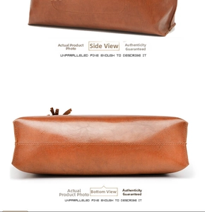 Detail view of brown vintage bucket bag showing fine stitching and oil wax leather texture
