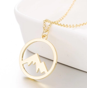 Golden stainless steel mountain pendant necklace with hollow circular silhouette design
