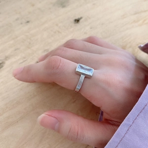 Close-up of 925 sterling silver ring with a rectangular cubic zirconia on finger