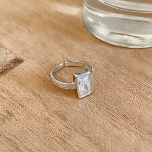 Detailed macro view of S925 sterling silver stamp and rectangular cubic zirconia on a ring