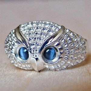 Creative silver owl ring featuring blue cat eye stone eyes and detailed feather texture